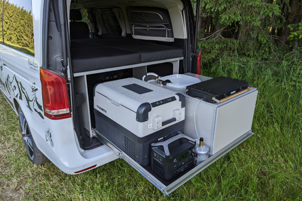 Side view of rear pull-out Riva with sleeping system in Mercedes van